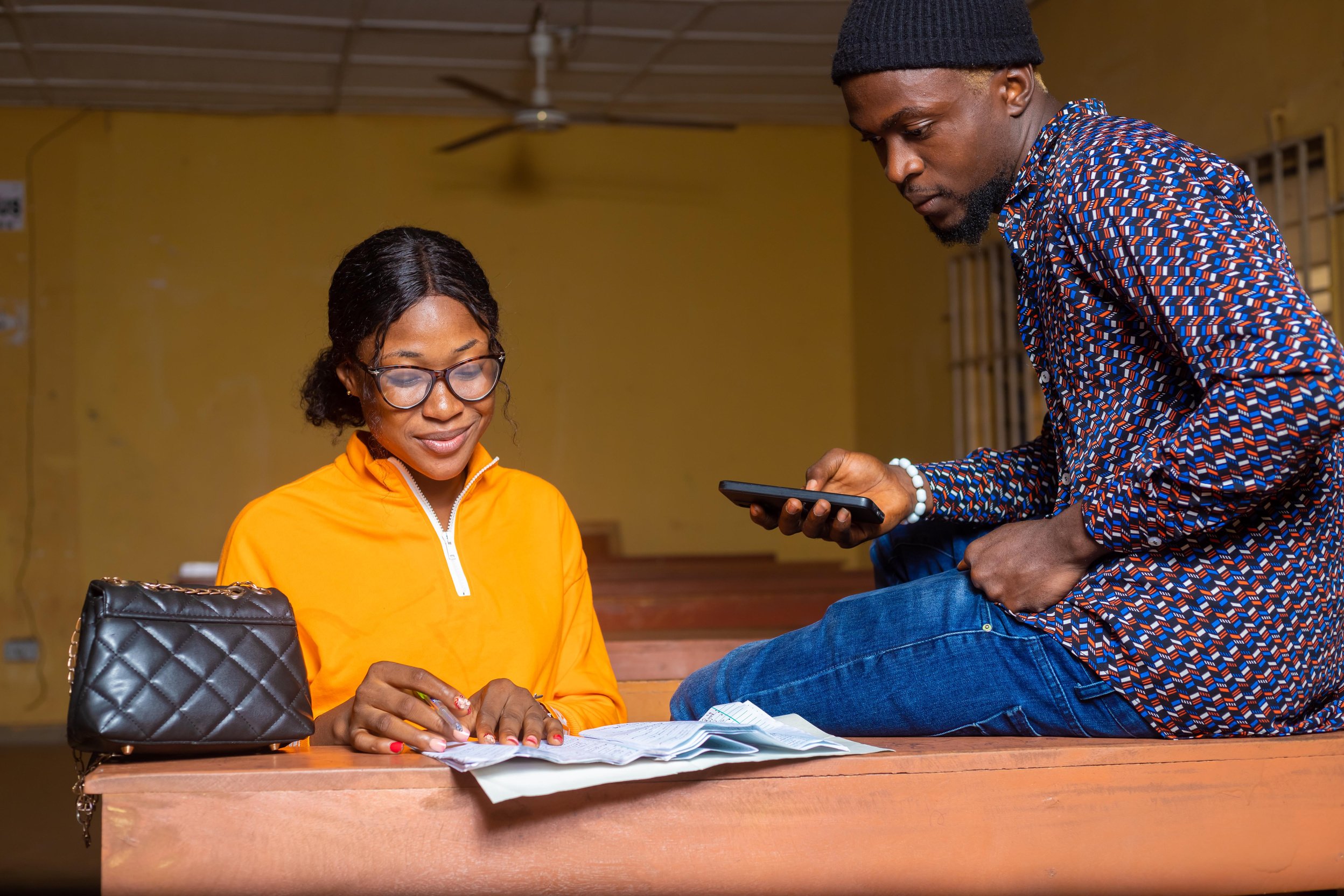 High School Tutor Giving Male Student One To One Tuition At