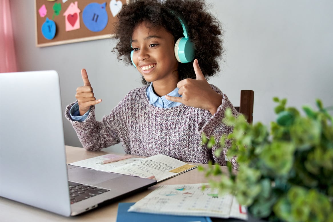 Smiling Deaf African girl on a virtual therapy session